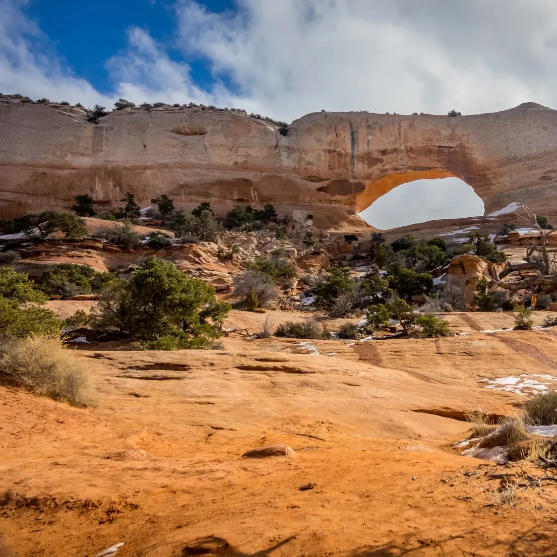 Wilson Arch, a natural sandstone arch in the red rock landscape of southeastern Utah.