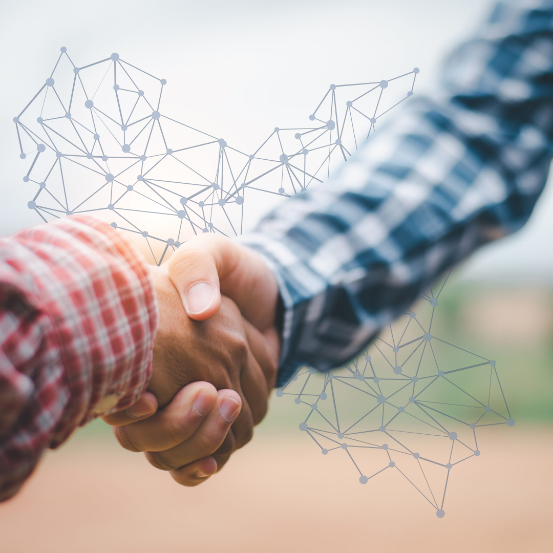Handshake between partners with a digital data network overlay symbolizing collaboration and sustainable change in rural healthcare.