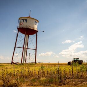 A wide shot of a leaning water town in rural Britten, Texas.