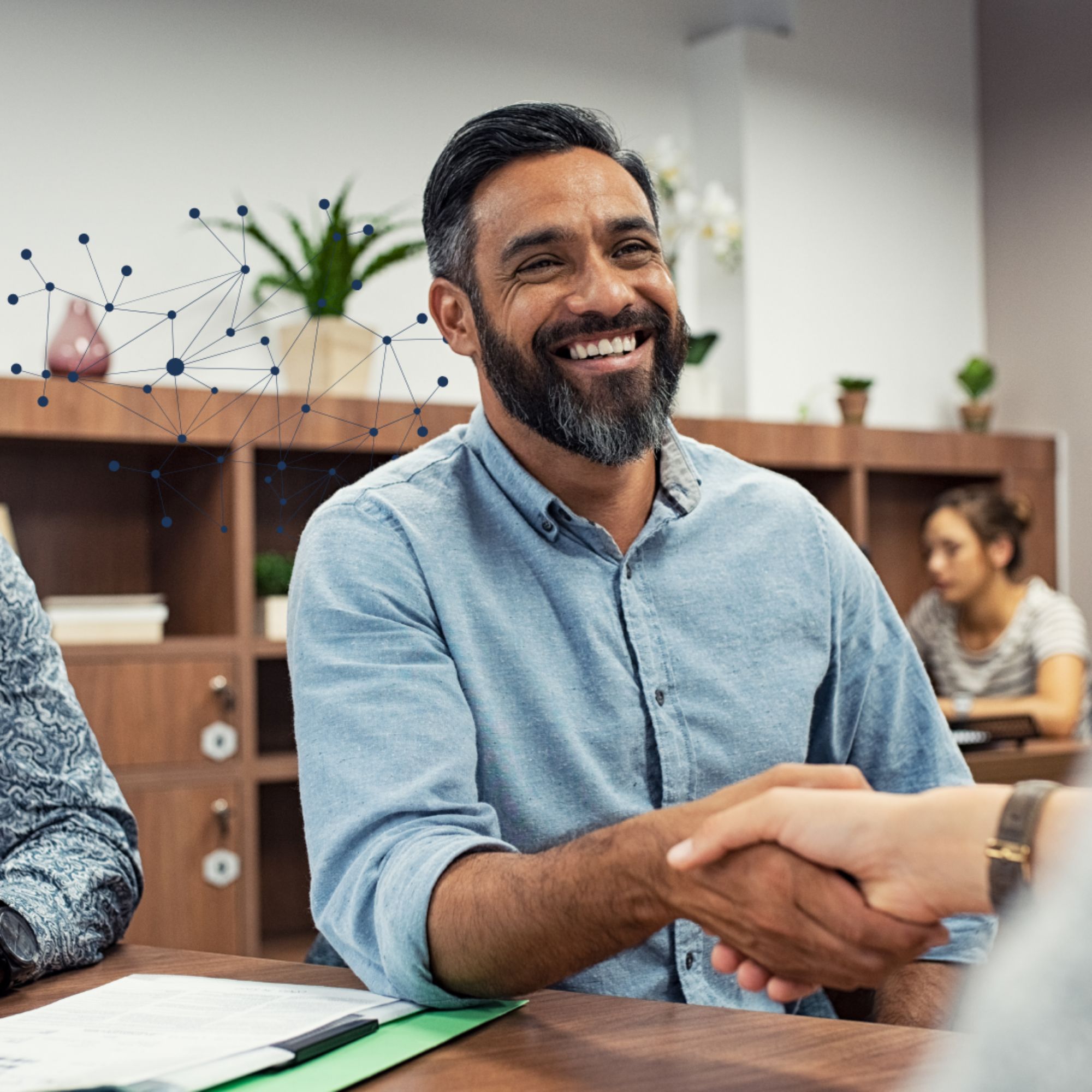 Healthcare professionals shaking hands during a collaborative meeting focused on improving rural hospital performance through data and analytics.