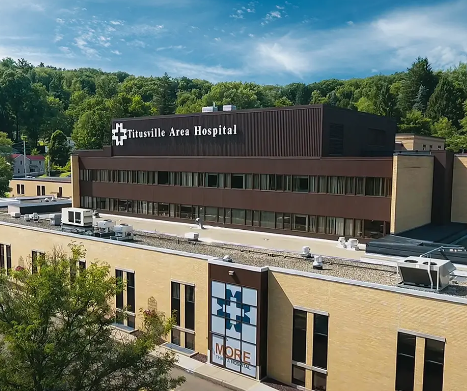 Aerial view of Titusville Area Hospital, a critical access hospital in northwest Pennsylvania, surrounded by wooded hills.