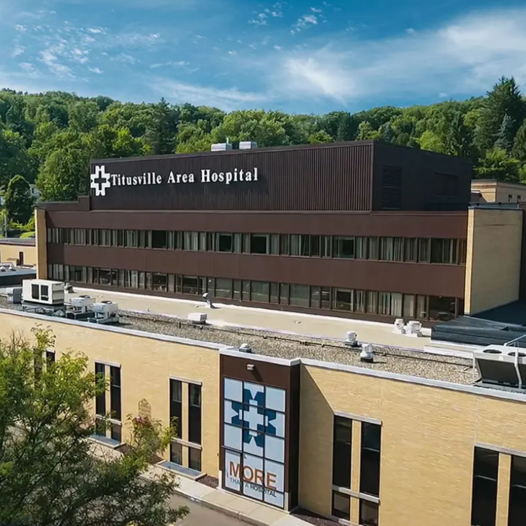 Aerial view of Titusville Area Hospital, a critical access hospital in northwest Pennsylvania, surrounded by wooded hills.