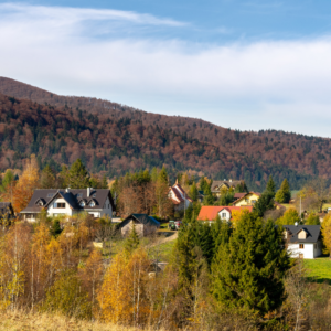 Rural community surrounded by autumn trees and rolling mountains, representing communities impacted by the Rural Health Transformation Program.