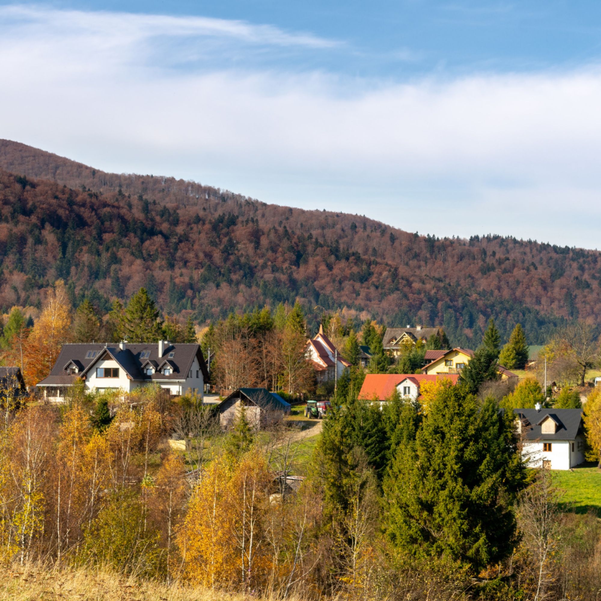 Rural community surrounded by autumn trees and rolling mountains, representing communities impacted by the Rural Health Transformation Program.