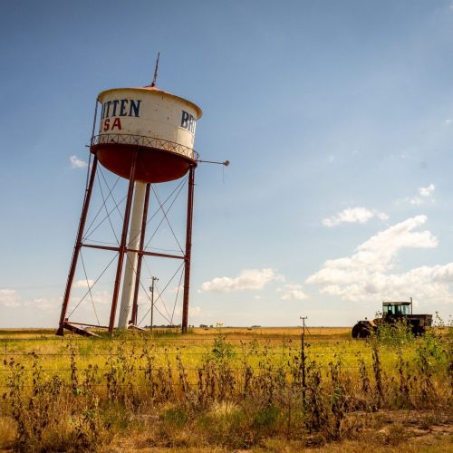 A wide shot of a leaning water town in rural Britten, Texas.