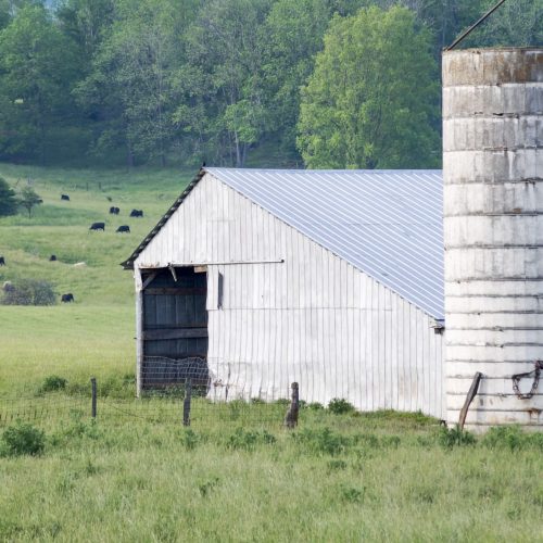 Barn and silo overlooking a rural farming community, reflecting REDi Health's commitment to strengthening rural hospitals, improving financial stability, and supporting access to care in underserved areas.