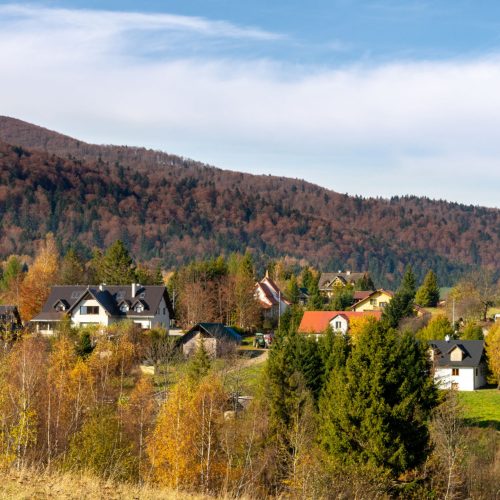 Rural community surrounded by autumn trees and rolling mountains, representing communities impacted by the Rural Health Transformation Program.