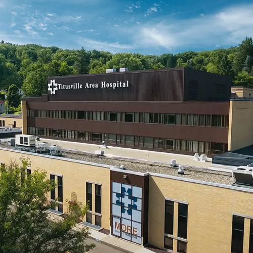 Aerial view of Titusville Area Hospital, a critical access hospital in northwest Pennsylvania, surrounded by wooded hills.
