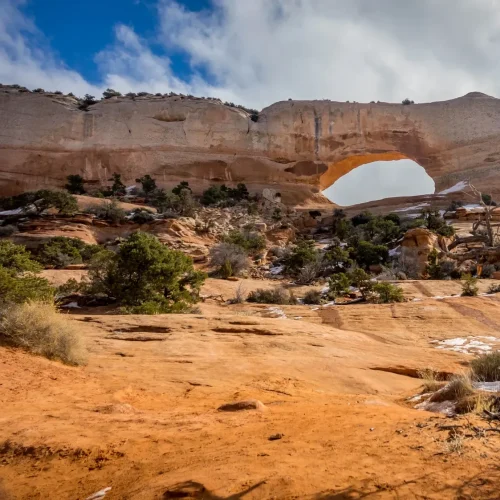 Wilson Arch, a natural sandstone arch in the red rock landscape of southeastern Utah.